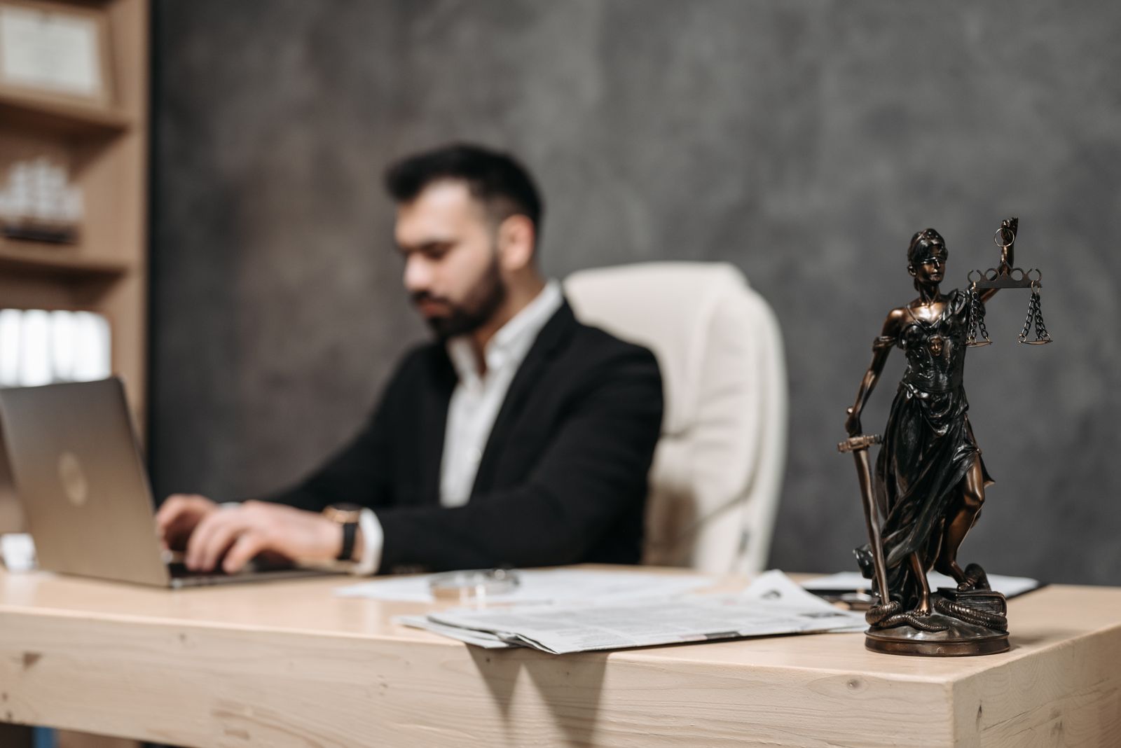 Illustrative desk detail with a scales-of-justice figure, not the actual chambers