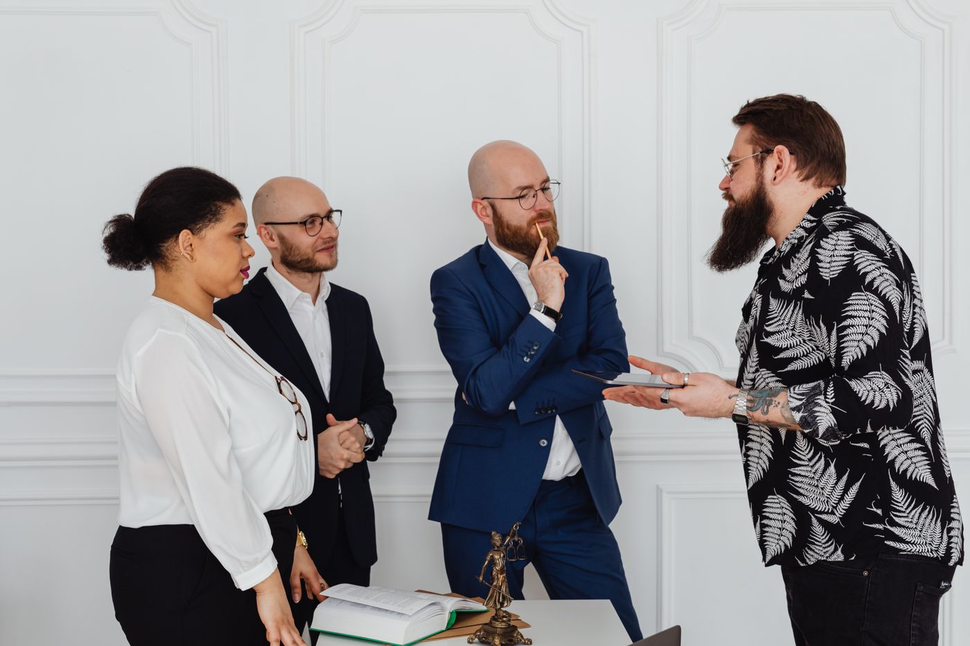 Illustrative legal professionals in a strategy conference, not the actual chambers
